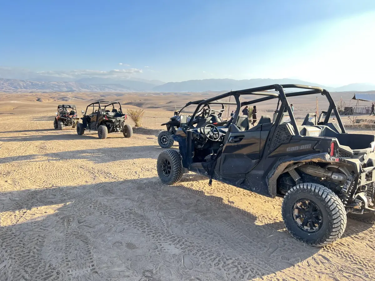 A convoy of buggies heading across the Agafay Desert towards a desert camp